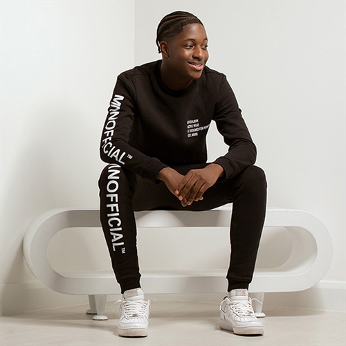 Photoshoot for Him Guy sitting on white stool Photoshoot for Him Guy sitting on white stool