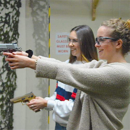 Duo shooting pistols at gun range
