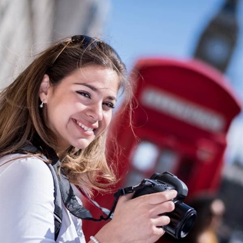 Lady taking photos of the red phone box Lady taking photos of the red phone box