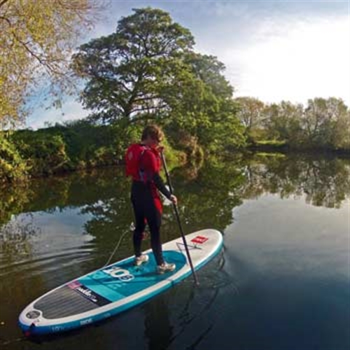 man standing on paddleboard man standing on paddleboard