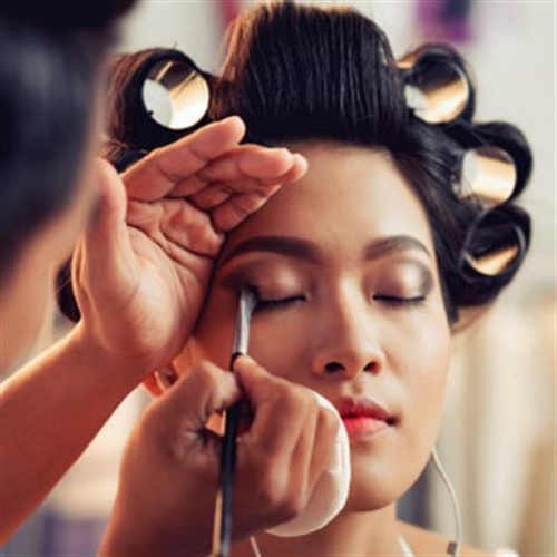 woman putting make-up on woman putting make-up on
