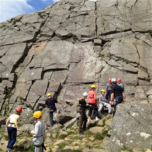 man learning how to rock climb man learning how to rock climb