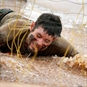 man crawling on assault course